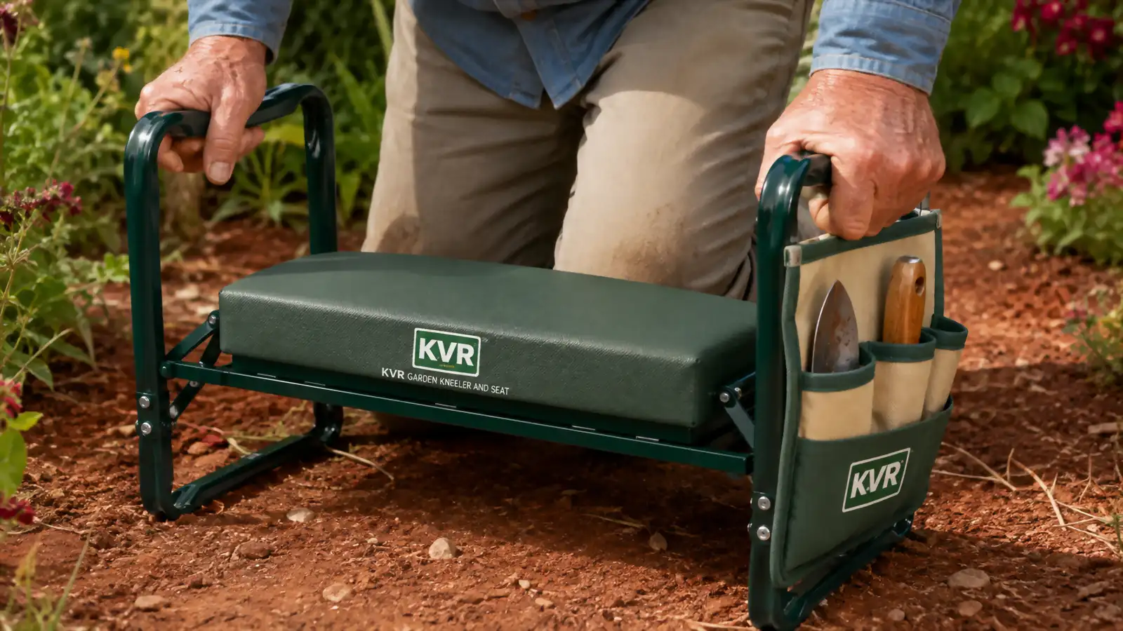 Close-up of hands gripping the steel side rails of the KVR kneeler with the tool pouches visible